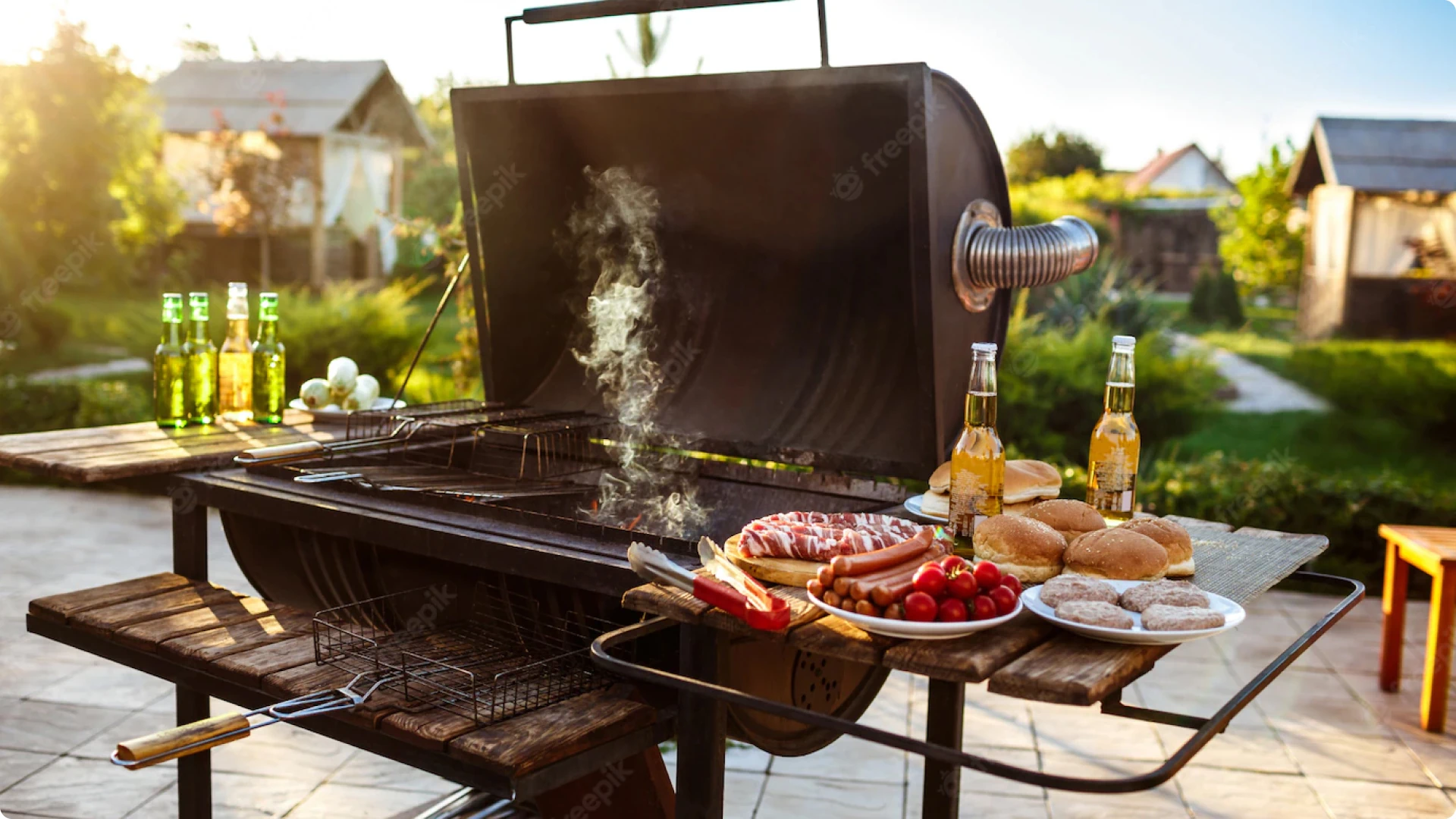 A grill with food on it and beer bottles.